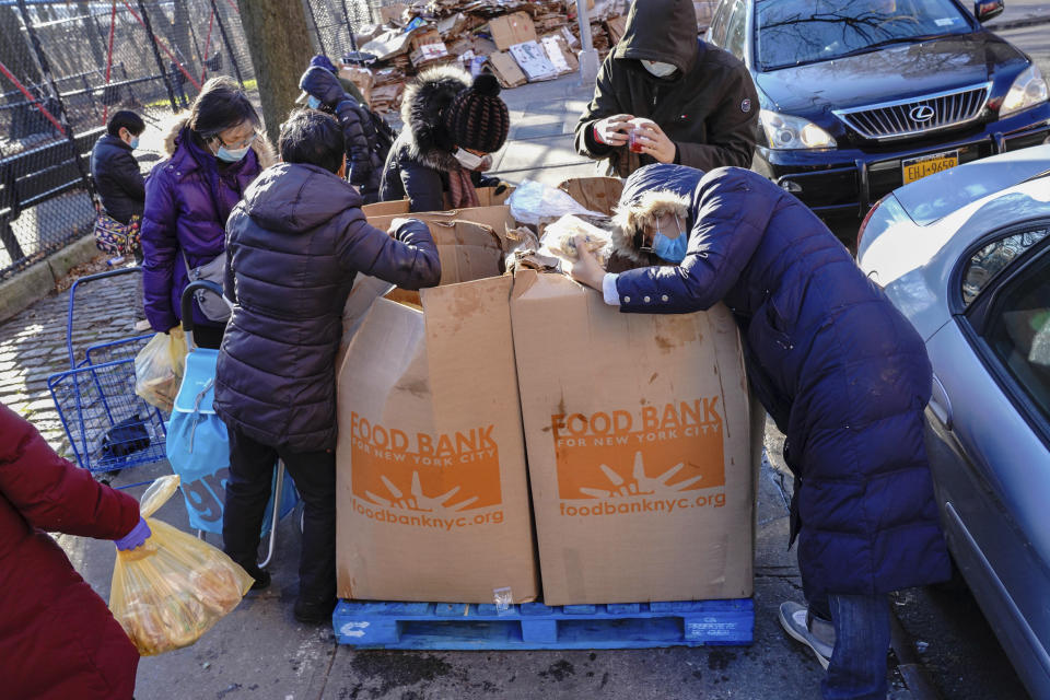 Photo by: John Nacion/STAR MAX/IPx 2020 12/26/20 People are seen rummaging through leftover Food Bank boxes in Flushing Borough of Queens, a day after Christmas Day on December 26, 2020.