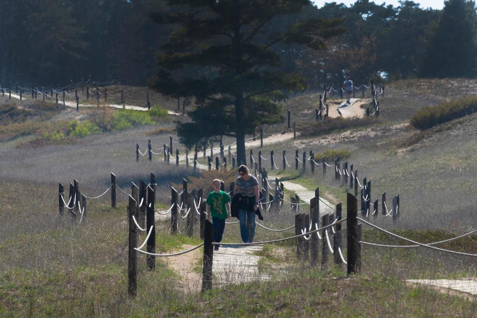 People hike the Kohler Dunes cord walk in May 2021 at the north end of Kohler-Andrae State Park.