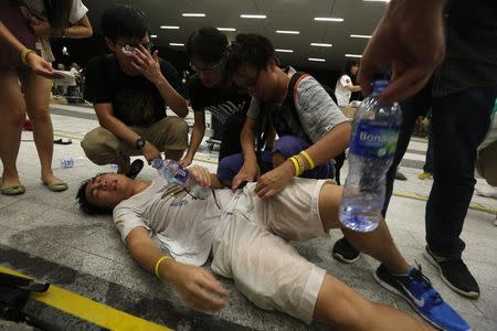 A protester receives help after being pepper sprayed during a confrontation with the police, following a rally for the October 1 "Occupy Central" civil disobedience movement in Hong Kong September 27, 2014. REUTERS/Bobby Yip