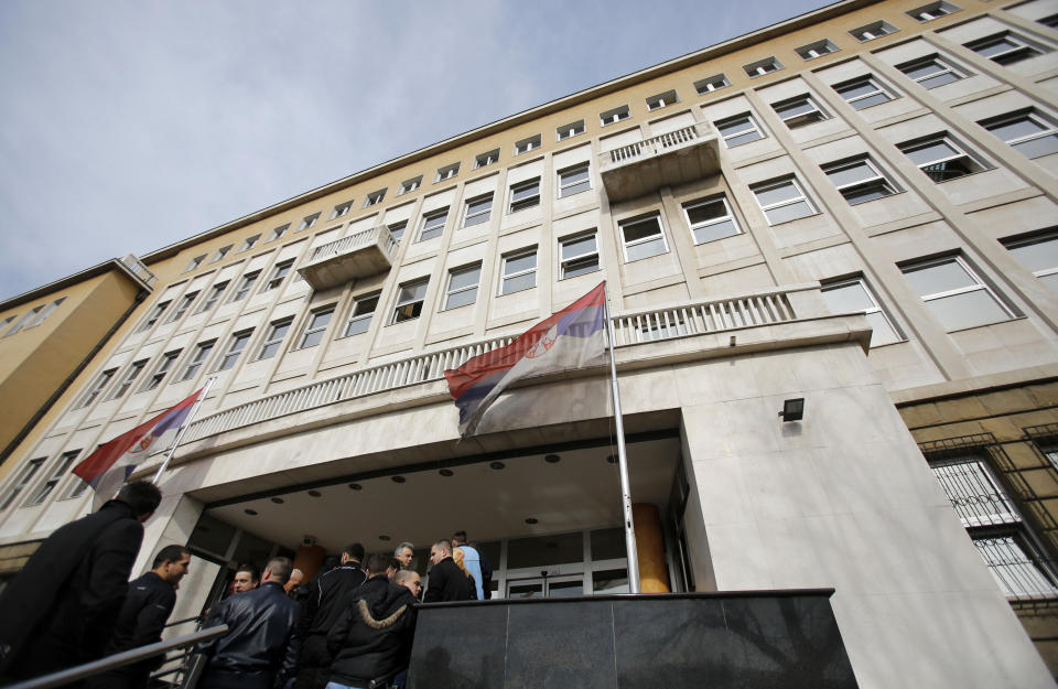 Former paramilitaries and their family members arrive at the Serbia's war crimes court in Belgrade, Serbia, Tuesday, Feb. 11, 2014. Serbia's war crimes court on Tuesday convicted nine former paramilitaries of the brutal killings of more than 100 ethnic Albanian civilians during the Kosovo war and sentenced them to between two and 20 years in prison. (AP Photo/Darko Vojinovic)