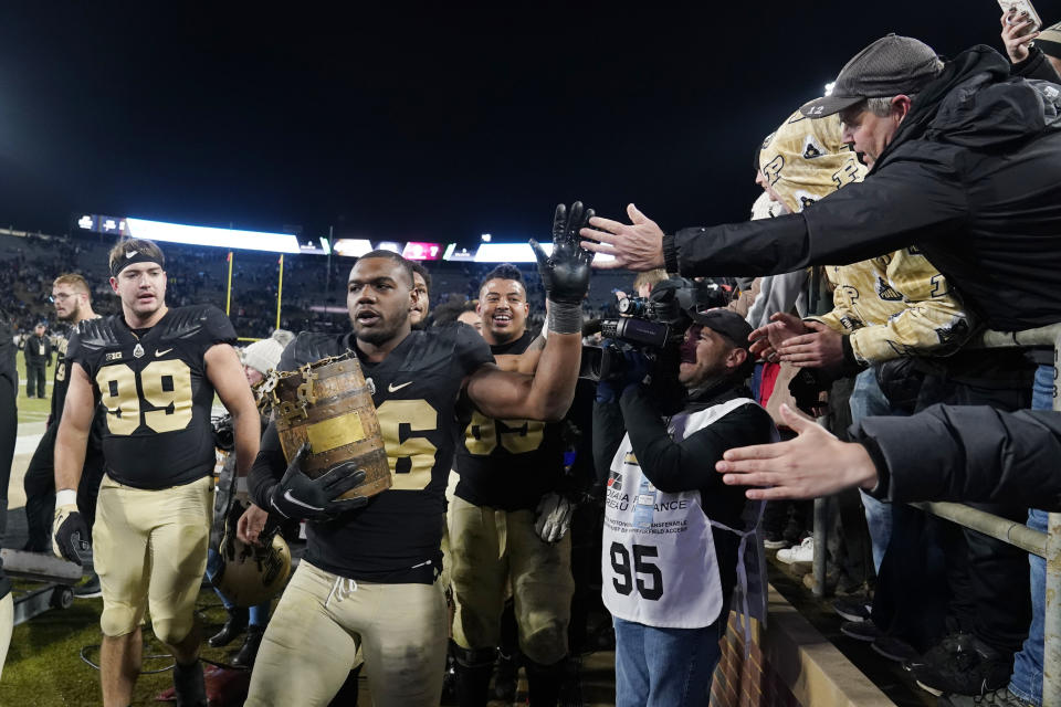 Purdue linebacker Jaylan Alexander (36) carries the Old Oaken Bucket after Purdue defeated Indiana 44-7 in an NCAA college football game, Saturday, Nov. 27, 2021, in West Lafayette, Ind.(AP Photo/Darron Cummings)