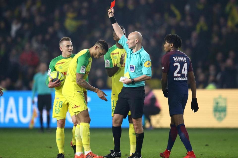 Nantes' Diego Carlos is shown a red card by referee Tony Chapron (REUTERS)