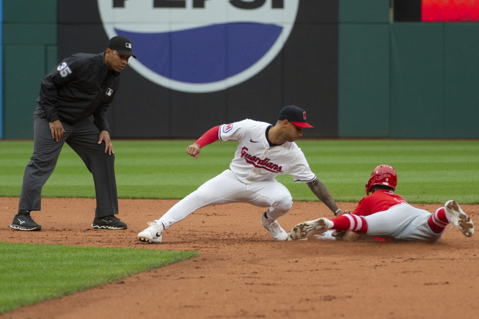 Cleveland Guardians' Brayan Rocchio, center, is late with a tag as Los Angeles Angels' Zach Neto, right, steals second base and umpire Jeremie Rehak watches during the fifth inning of a baseball game in Cleveland, Saturday, May 4, 2024. (AP Photo/Phil Long)