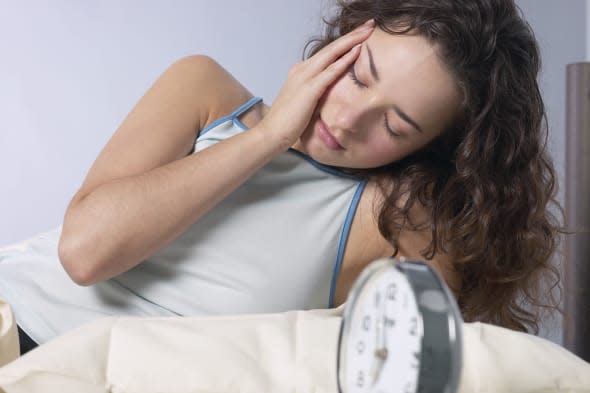 Tired woman in bed