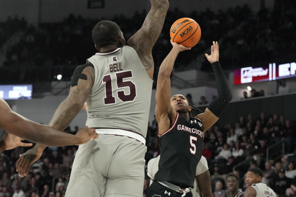 South Carolina guard Meechie Johnson (5) attempts a shot past Mississippi State forward Jimmy Bell Jr. (15) during the first half of an NCAA college basketball game, Saturday, March 9, 2024, in Starkville, Miss. (AP Photo/Rogelio V. Solis)