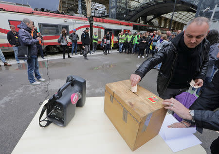 Railway workers cast their ballots as they vote about the strike at the Nice railway station on the second day of a nationwide strike by French SNCF railway workers in Nice, France, April 4, 2018. REUTERS/Eric Gaillard