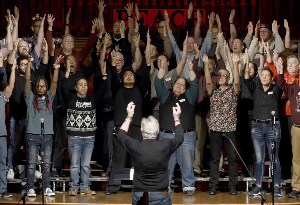 Bill Loper, interim artistic director of the Out Loud Colorado Springs Men's Chorus, leads the group during a rehearsal for its Christmas program in Colorado Springs, Colo., on Wednesday, Nov. 30, 2022. Gay and lesbian choruses like Out Loud came about after the assassination of San Francisco Supervisor Harvey Milk and have remained steadfast institutions through the civil rights struggles of the 20th century up to today. They've taken an active role in the healing process after mass shootings like that at Orlando's Pulse nightclub and the Nov. 19 attack at an LGBTQ nightclub in Colorado Springs that killed five people. (AP Photo/Thomas Peipert)