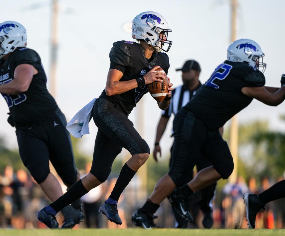 Brownsburg High School senior Jayden Whitaker (9) drops back to pass during the first half of an IHSAA varsity football game against Indianapolis Cathedral High School, Friday, Aug. 26, 2022, at Brownsburg High School.