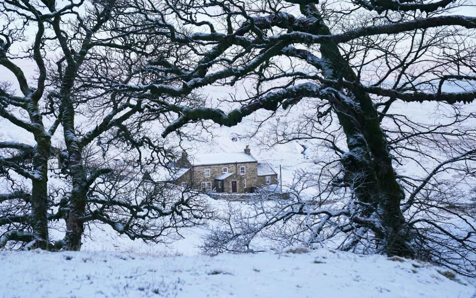 A snow covered cottage near Carrshield in Northumberland in March gives the perception that it has been a worse winter than normal - Owen Humphreys/PA