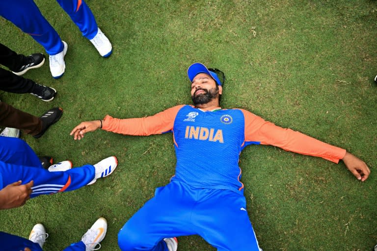 India's captain Rohit Sharma lays on the ground as he celebrates after winning the ICC men's Twenty20 World Cup 2024 final cricket match between India and <a class="link " href="https://sports.yahoo.com/soccer/teams/south-africa-women/" data-i13n="sec:content-canvas;subsec:anchor_text;elm:context_link" data-ylk="slk:South Africa;sec:content-canvas;subsec:anchor_text;elm:context_link;itc:0">South Africa</a> (CHANDAN KHANNA)