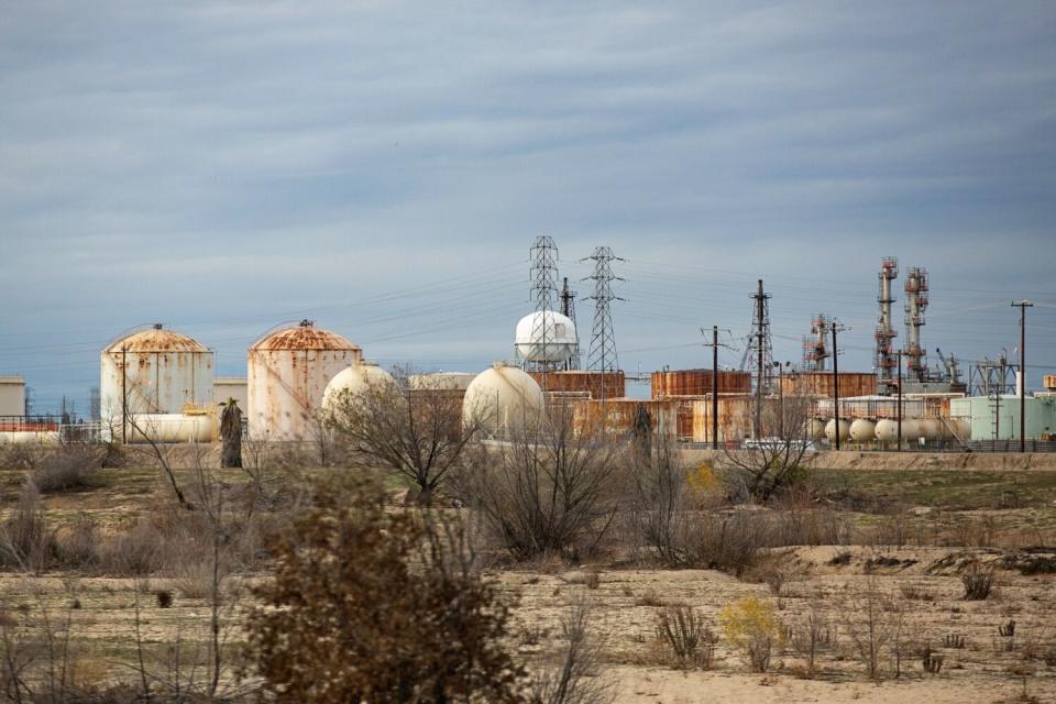 An industrial desert landscape with metal structures.