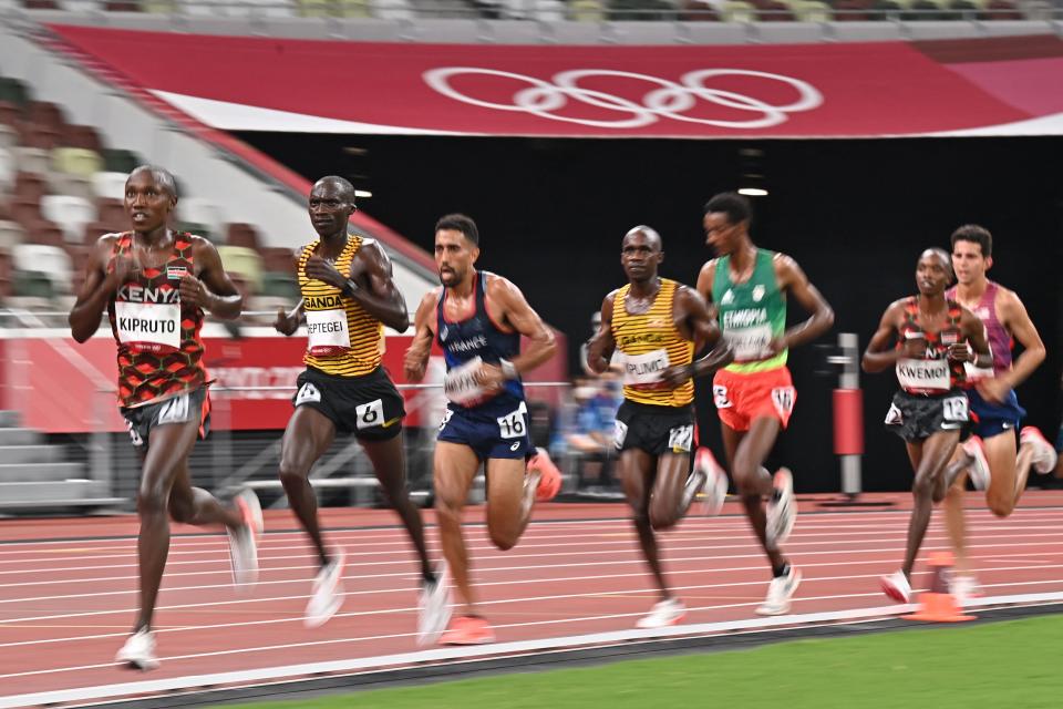 Kenya's Rhonex Kipruto (L), Uganda's Joshua Cheptegei (C) and France's Morhad Amdouni (R) compete in the men's 10000m final during the Tokyo 2020 Olympic Games at the Olympic Stadium in Tokyo on July 30, 2021. (Photo by Ben STANSALL / AFP) (Photo by BEN STANSALL/AFP via Getty Images)