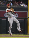 Los Angeles Angels third baseman Anthony Rendon makes an off-balance throw for an out on a ball hit by Arizona Diamondbacks' Christian Walker in the first inning during a baseball game, Sunday, June 13, 2021, in Phoenix. (AP Photo/Rick Scuteri)