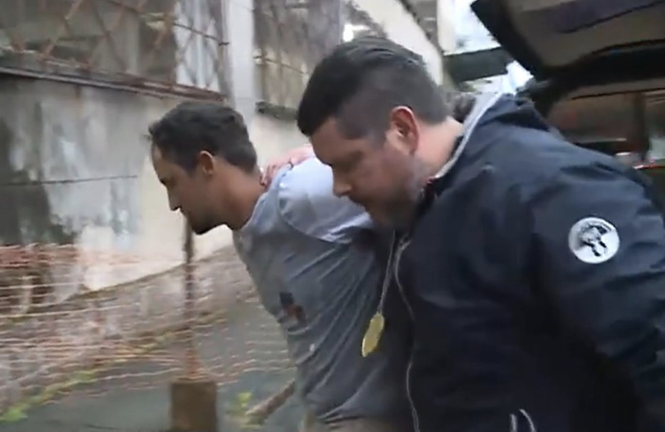 Police walking with a man after he's been arrested. 