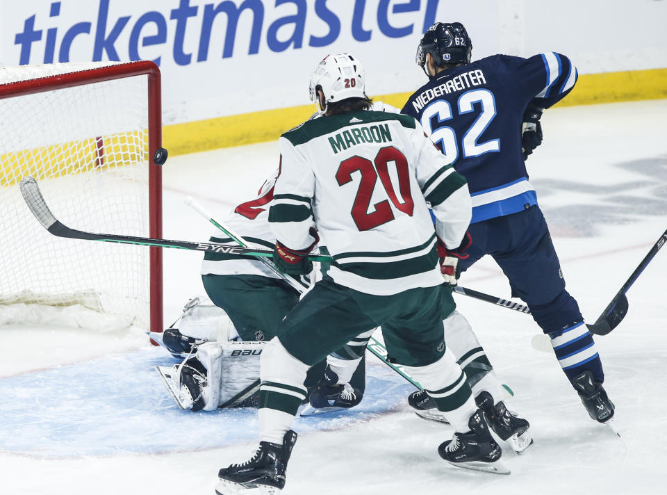 Winnipeg Jets' Nino Niederreiter's (62) shot goes off the post past Minnesota Wild goaltender Filip Gustavsson (32)during the first period of an NHL hockey game, Saturday, Dec. 30, 2023 in Winnipeg, Manitoba. (John Woods/The Canadian Press via AP)