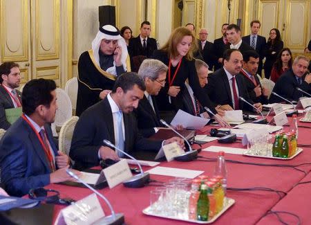 Saudi Arabia's Foreign Minister Adel Al-Jubeir (3rd L, standing) walks up to talk with U.S. Secretary of State John Kerry at the start of a ministerial meeting on Syria at the Quai d'Orsay, Ministry of Foreign Affairs, in Paris in this file photo dated December 14, 2015. REUTERS/Mandel Ngan/Pool