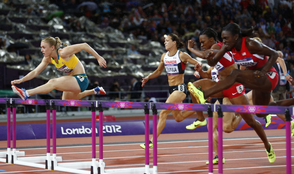 Australia's Sally Pearson (front) clears a hurdle to win gold in the women's 100m hurdles final during the London 2012 Olympic Games at the Olympic Stadium August 7, 2012. REUTERS/Kai Pfaffenbach (BRITAIN - Tags: OLYMPICS SPORT ATHLETICS) 