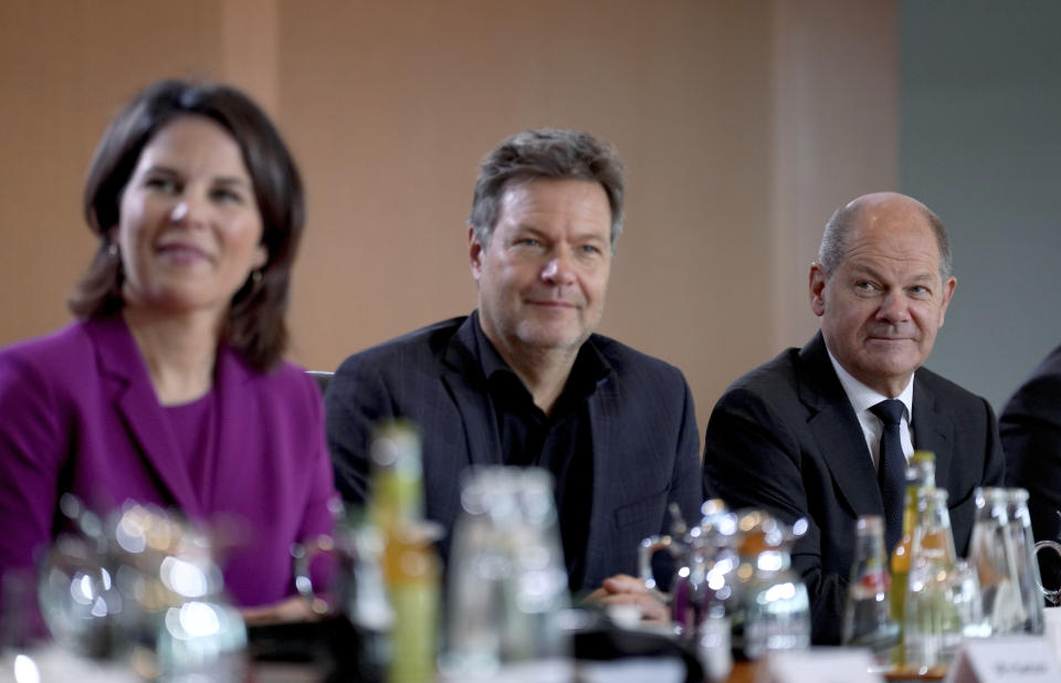 From right, German Chancellor Olaf Scholz, German Economy and Climate Minister Robert Habeck and German Foreign Minister Annalena Baerbock pose for a group photo prior to the the weekly cabinet meeting at the Chancellery in Berlin, Germany, Wednesday, Nov. 9, 2022. (AP Photo/Michael Sohn)