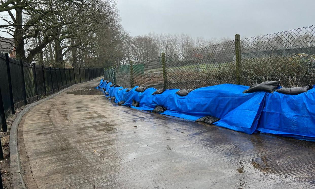<span>Sandbags lined up along the inside perimeter of the Horley treatment works in an attempt to stop sewage spilling on to the footpath. </span><span>Photograph: Keith Barlow</span>