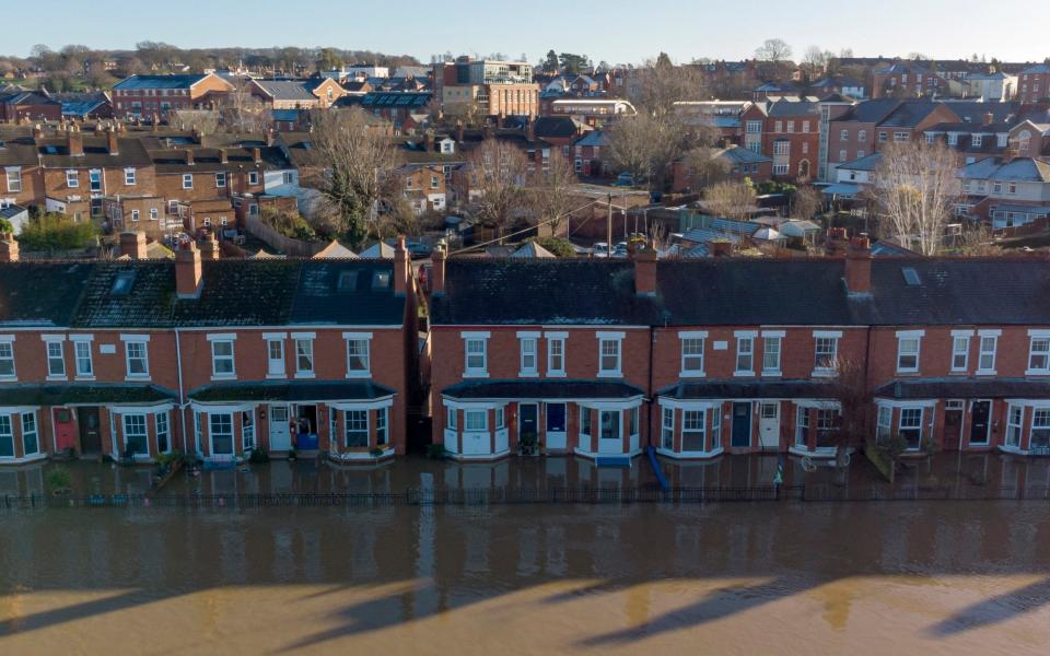 An aerial view of a row of residential houses submerged by flood water on January 22,2021 in Worcester, England - Getty 