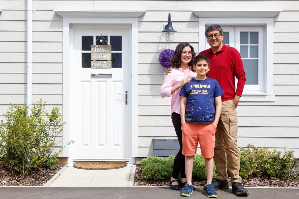 Eda and Yilmaz Bilgen with their son Baris outside their new home at Green Park Village in Reading (ES H&P)