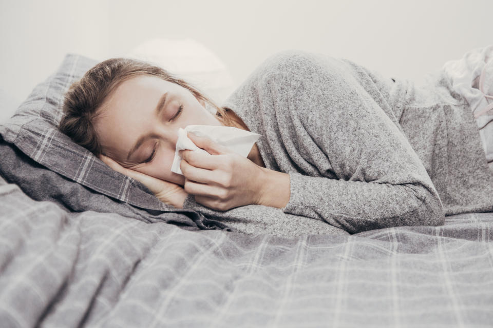 A woman lies in bed blowing her nose. According to the Child Health Poll by The Royal Children's Hospital in Melbourne, most parents don't know how to treat a cold and rely on outdated ways to keep kids healthy.
