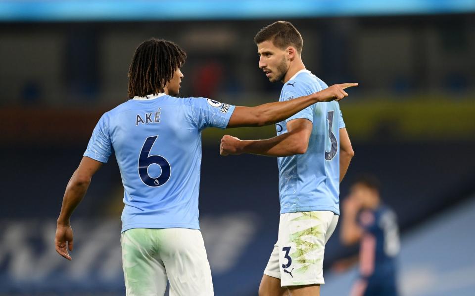 Ruben Dias (right) receives direction from Nathan Ake - PA