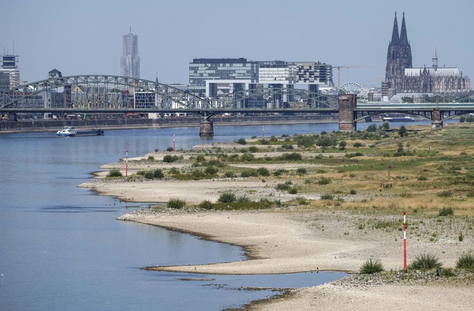 The river Rhine is pictured with low water in Cologne, Germany, Wednesday, Aug. 10, 2022. The low water levels are threatening Germany's industry as more and more ships are unable to traverse the key waterway. Severe drought will worsen in Europe in August as a hot and dry summer persists. (AP Photo/Martin Meissner)