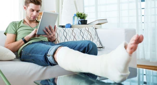 Young man broken leg sofa health insurance affordable care act