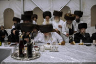 Yaakov Tabersky, left, blessed by Haharon Biderman, the chief rabbi of the Lelov Hassidic dynasty, during the "Pidyon Haben" ceremony for his son, Yossef, in Beit Shemesh, Israel, Thursday, Sept. 16, 2021. The Pidyon Haben, or redemption of the firstborn son, is a Jewish ceremony hearkening back to the biblical exodus from Egypt. (AP Photo/Oded Balilty)