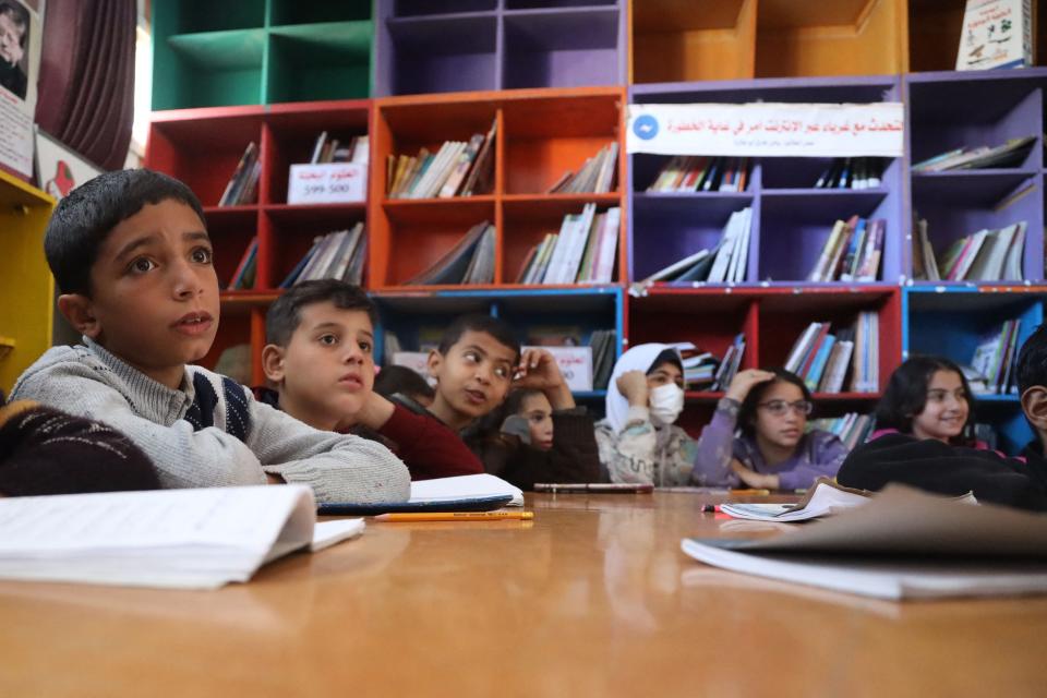 Palestinian children attend an English class in a school housing displaced Gazans in Rafah, in the southern Gaza Strip, on March 4, 2024.