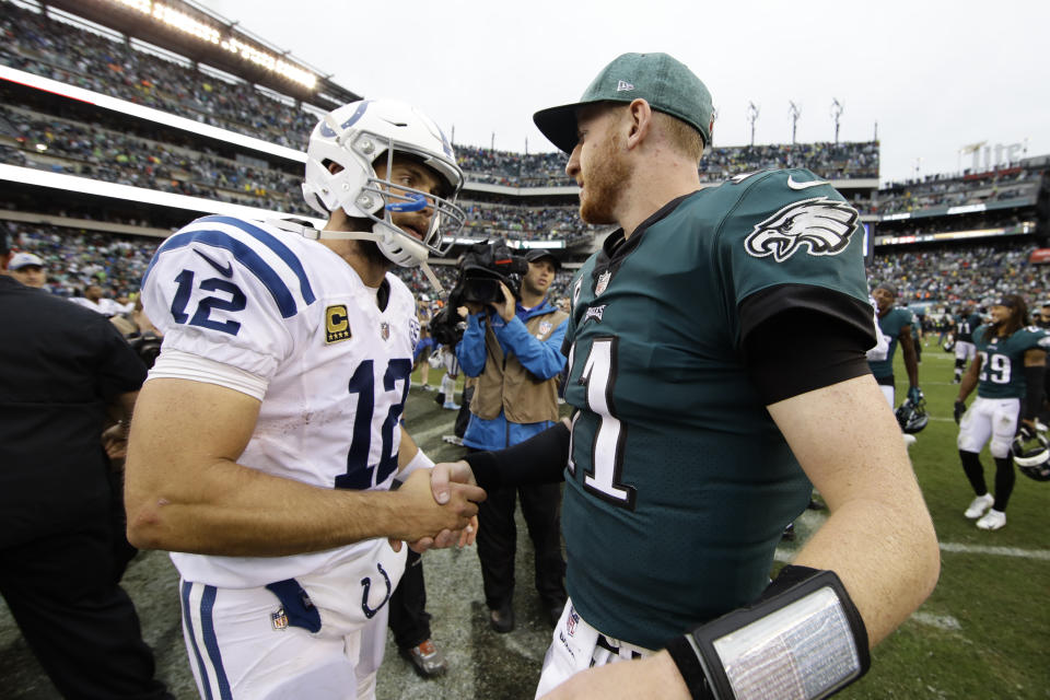 Indianapolis Colts' Andrew Luck, left, and Philadelphia Eagles' Carson Wentz (11) shake hands after an NFL football game, Sunday, Sept. 23, 2018, in Philadelphia. Philadelphia won 20-16. (AP Photo/Matt Rourke)
