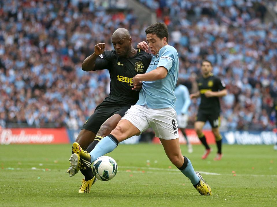 Manchester City's Samir Nasri and Wigan Athletic's Emmerson Boyce (left) battle for the ball