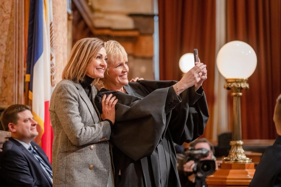 Iowa Supreme Court Chief Justice Susan Christensen takes a selfie with Gov. Kim Reynolds as she gives the Condition of the Judiciary to a joint session at the Iowa State Capitol, Wednesday, Jan. 11, 2023.
