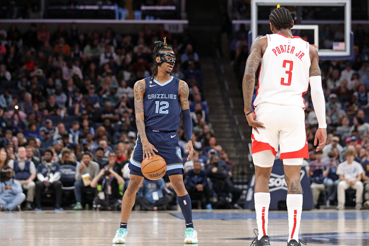 MEMPHIS, TENNESSEE - MARCH 22: Ja Morant #12 of the Memphis Grizzlies handles the ball against Kevin Porter Jr. #3 of the Houston Rockets during the first half at FedExForum on March 22, 2023 in Memphis, Tennessee. NOTE TO USER: User expressly acknowledges and agrees that, by downloading and or using this photograph, User is consenting to the terms and conditions of the Getty Images License Agreement. (Photo by Justin Ford/Getty Images)