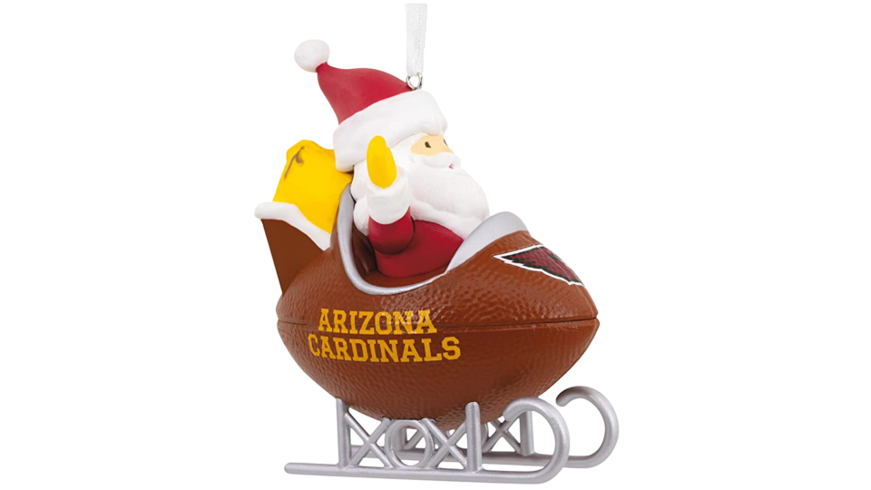 Santa in football sled with Cardinals logo in front.