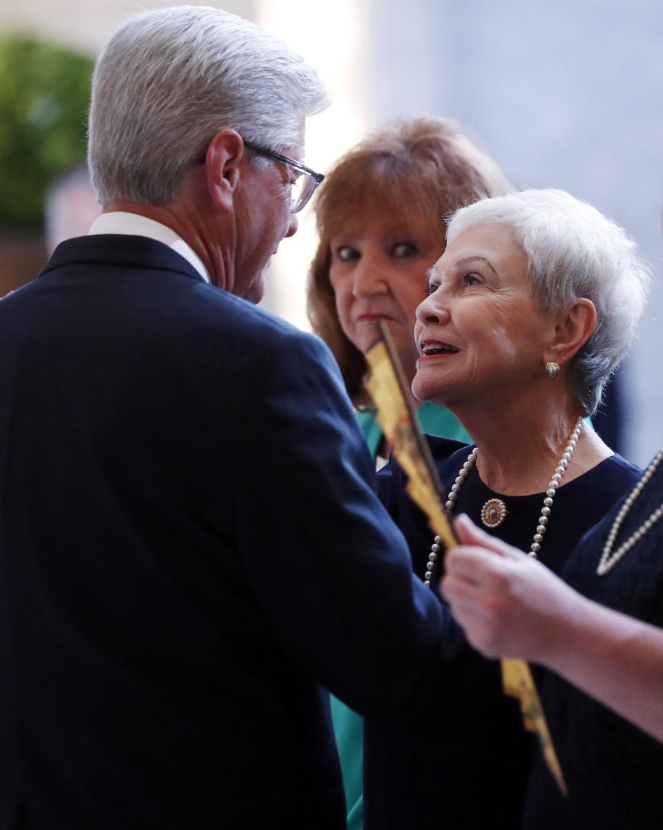 Kay Webber Cochran, right, widow of the late former U.S. Senator Thad Cochran, speaks with Mississippi Gov. Phil Bryant, left, during the first of two funeral services for the late Republican senator Thad Cochran, in the Mississippi State Capitol rotunda in Jackson, Miss., Monday, June 3, 2019. Cochran was 81 when he died Thursday in a veterans' nursing home in Oxford, Mississippi. He was the 10th longest serving senator. (AP Photo/Rogelio V. Solis)