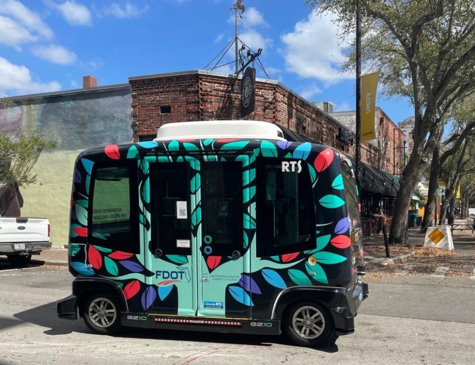 The rubber-tired autonomous shuttle used in a Gainesville pilot project goes down a street in this file photo.