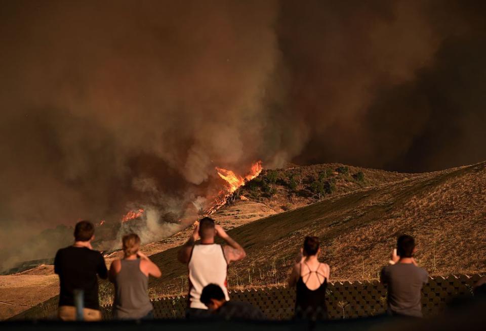 <p>Local residents watch a blaze dubbed the 'Sand Fire' as it moves towards Fair Oaks Canyon housing estate in Santa Clarita, California on July 24, 2016. </p>