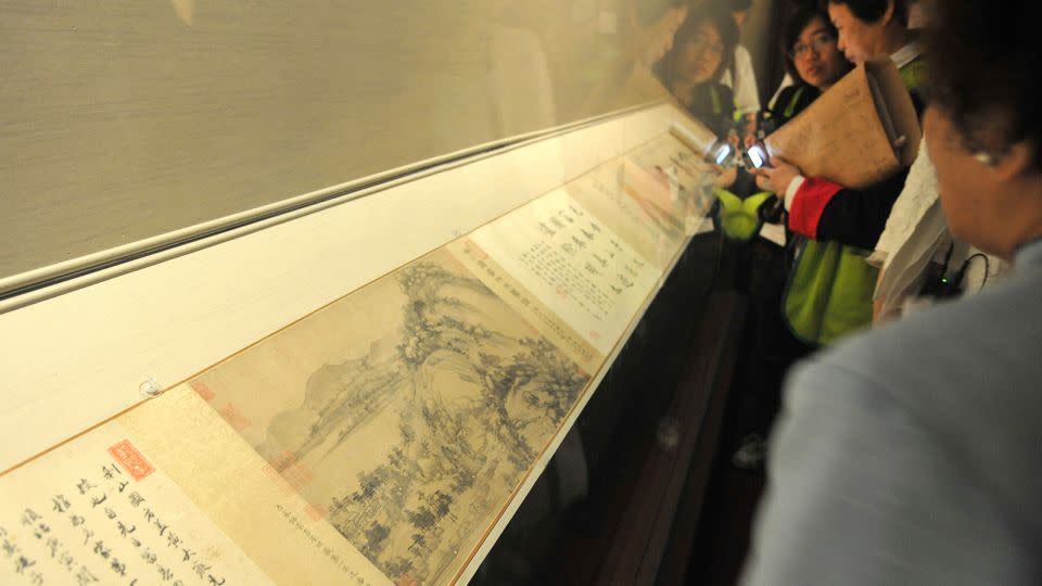 Visitors look at "Dwelling in the Fuchun Mountains" at the National Palace Museum Taipei on June 1, 2011. - Patrick lin/AFP/Getty Images