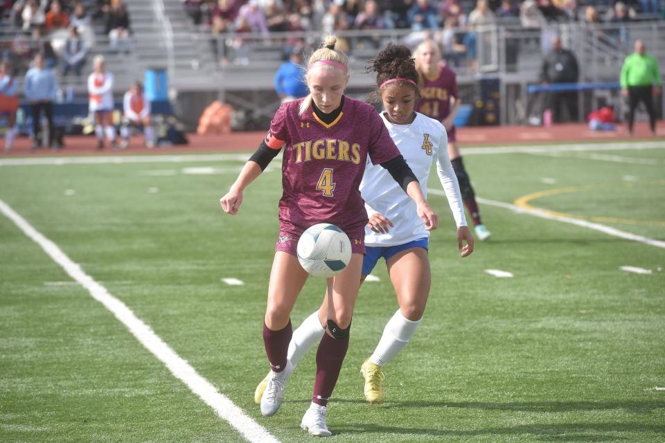 Harrisburg junior Ella Weide keeps the ball in front of her as Aberdeen Central's Deshani Peters defends in the girls Class AA state final at Tea Area high school on Saturday.