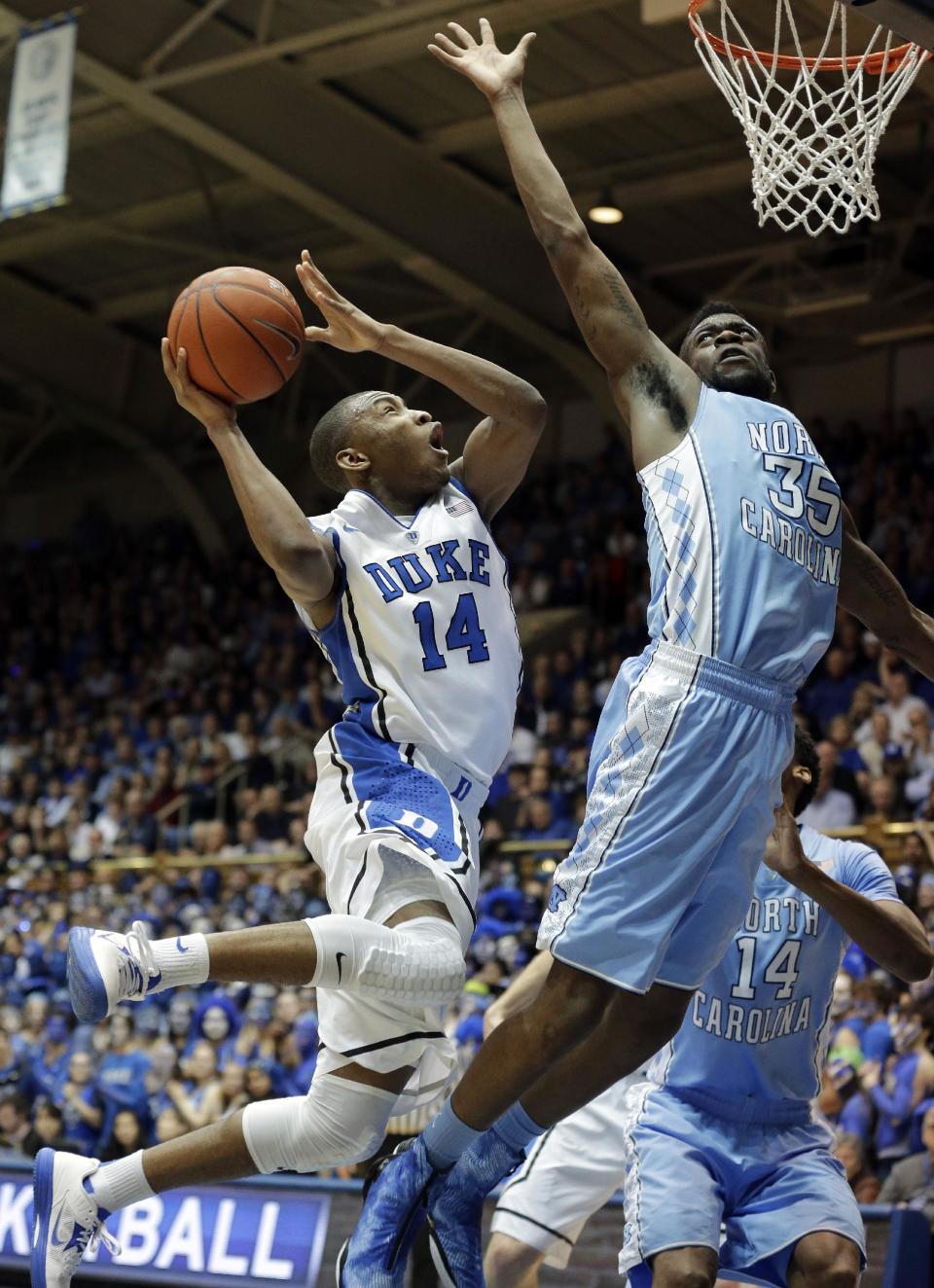 Duke's Rasheed Sulaimon (14) drives to the basket as North Carolina's Reggie Bullock (35) defends during the first half of an NCAA college basketball game in Durham, N.C., Wednesday, Feb. 13, 2013. (AP Photo/Gerry Broome)