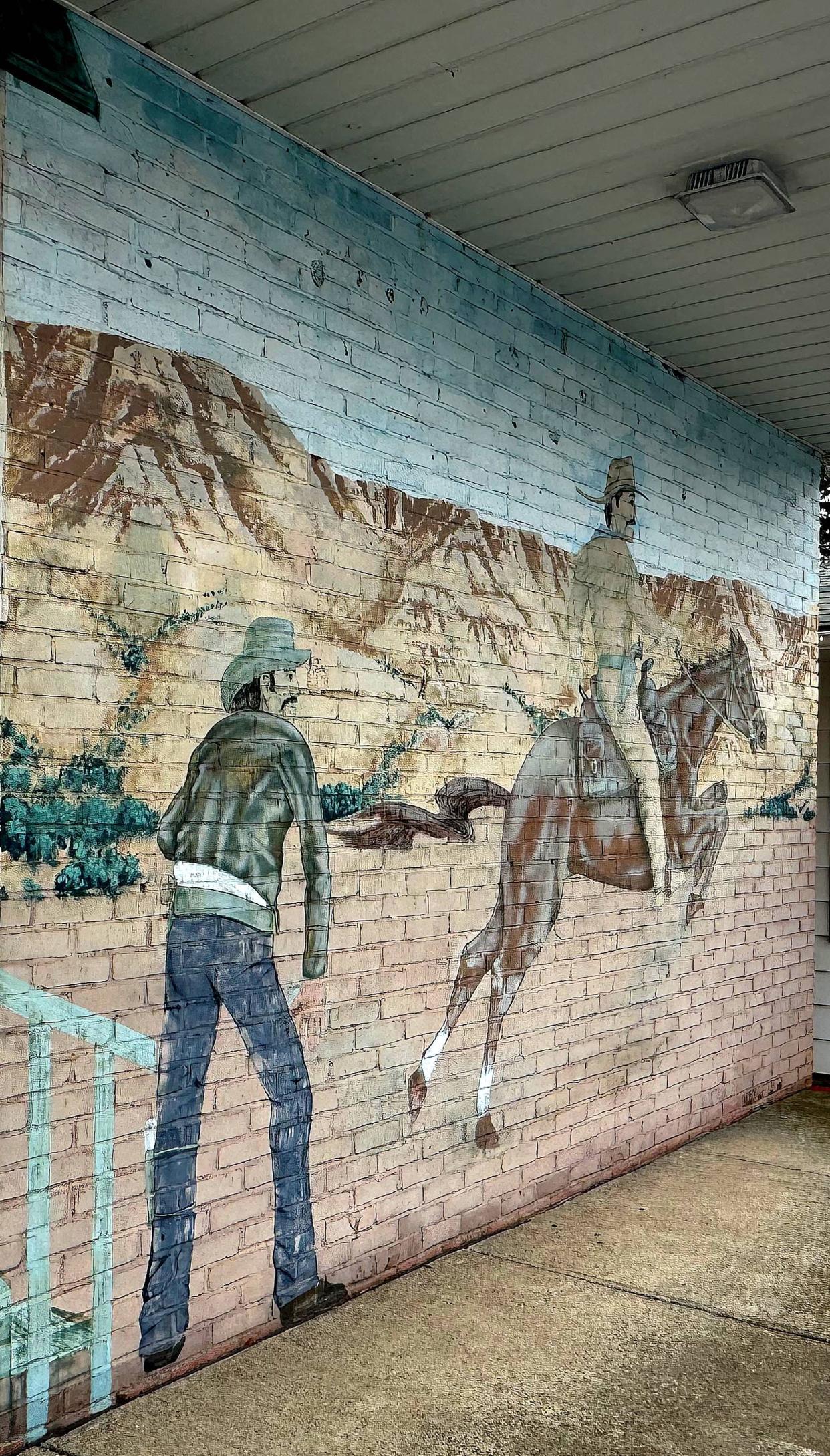 The Pony Express pack and ship store at 1903 W. Eighth St., bears a mural based on its name. The store, which opened in 1986, is for sale by owners Dave and Terry Grab.