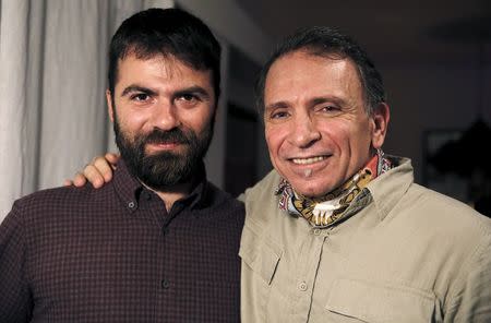 Photographers Alkis Konstantinidis (L) and Yannis Behrakis pose for a photograph in Athens, Greece April 18, 2016. Konstantinidis and Behrakis were part of a Reuters team entry on the migrant crisis in Europe and the Middle East, which was awarded the Pulitzer Prize for breaking news photography. REUTERS/Yannis Behrakis