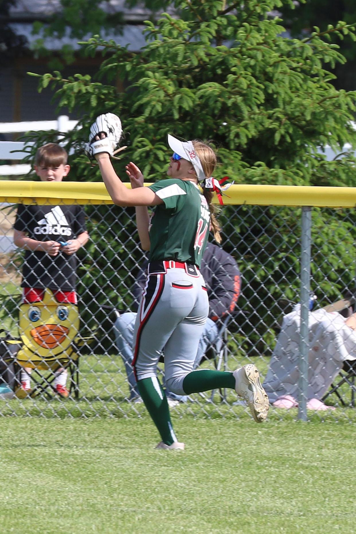 Oak Harbor's Alyse Sorg tracks down a fly ball in center field.