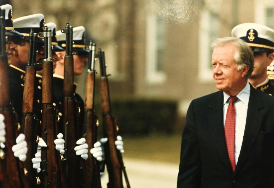 Ex-president Jimmy Carter reviews the troops during a visit at the U. S. Coast Guard Academy in New London March 11, 1988.