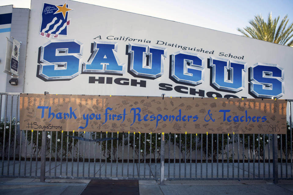 A sign thanking first responders and teachers hangs, Monday, Nov. 18, 2019, after two students were killed during a shooting at Saugus High School in Santa Clarita, Calif., several days earlier. Students will return to school on Dec. 2. (Sarah Reingewirtz/The Orange County Register via AP)