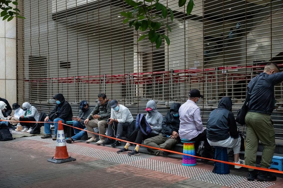 People wait in line outside the West Kowloon Magistrates' Courts in Hong Kong, Thursday (AP)