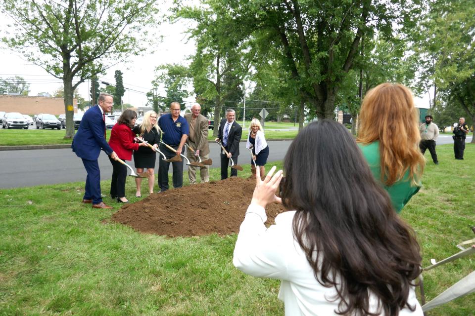 County employees take photos of county officials and architect David McHenry (left) breaking ground for the new Lower Bucks Government Services Center in Bristol Township Thursday.