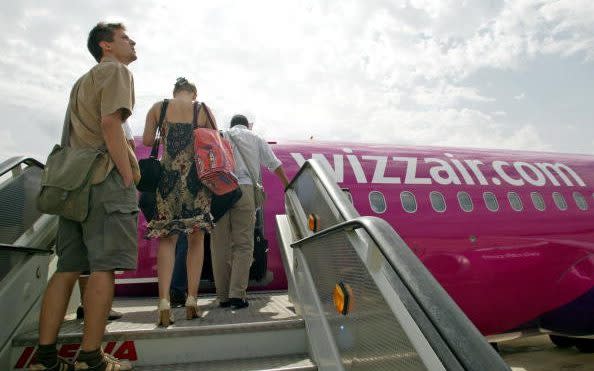 Passengers board a Wizz Air aircraft at Girona Airport, Spain in September 2004